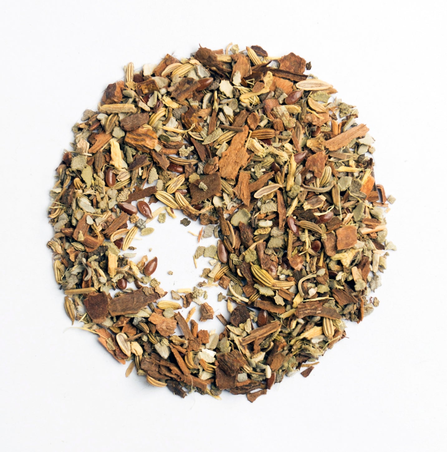 A circle of Menopause Daytime Tea Blend by Bondi Beach Tea Co on a white background, featuring an organic mix of dried fennel seeds, cinnamon, and ginger pieces. This aromatic and textured herbal tea offers an invigorating experience with its natural ingredients.