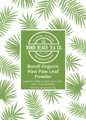A pattern of green palm leaves encases a green label with white text: Bondi Beach Tea Co. Bondi Organic Paw Paw/Papaya Leaf Powder. Celebrated for centuries, this 75g powder aids digestion and enhances the immune system.