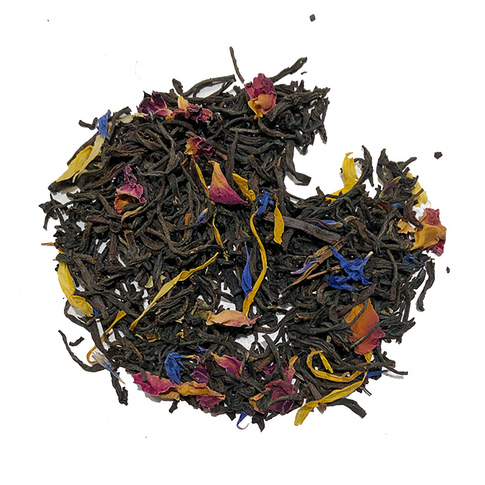 A vibrant mix of organic black tea leaves with small dried red, yellow, and blue flower petals embodies the floral flavor of Bondi Beach Tea Cos French Earl Grey Tea Blend on a white background.