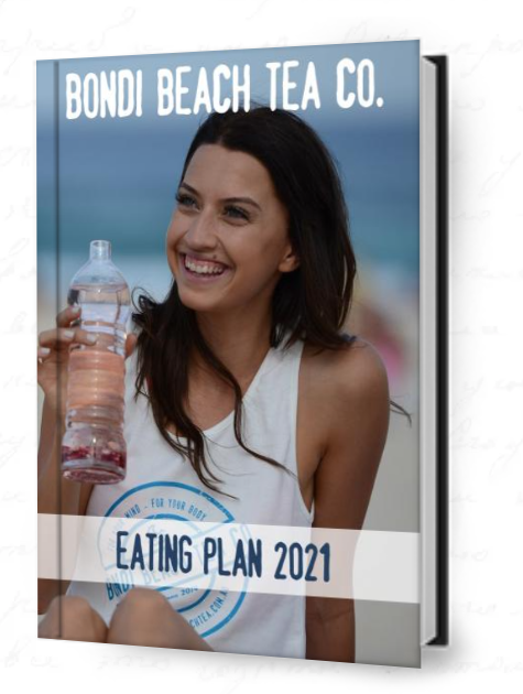 A woman smiles at the beach, holding a bottle filled with pink liquid. Shes wearing a white tank top with the Bondi Beach Tea Co. logo. The text reads: Bondi Beach Tea Co and FREE Eating Plan 2021, showcasing serenity and vitality against a sandy beach backdrop.